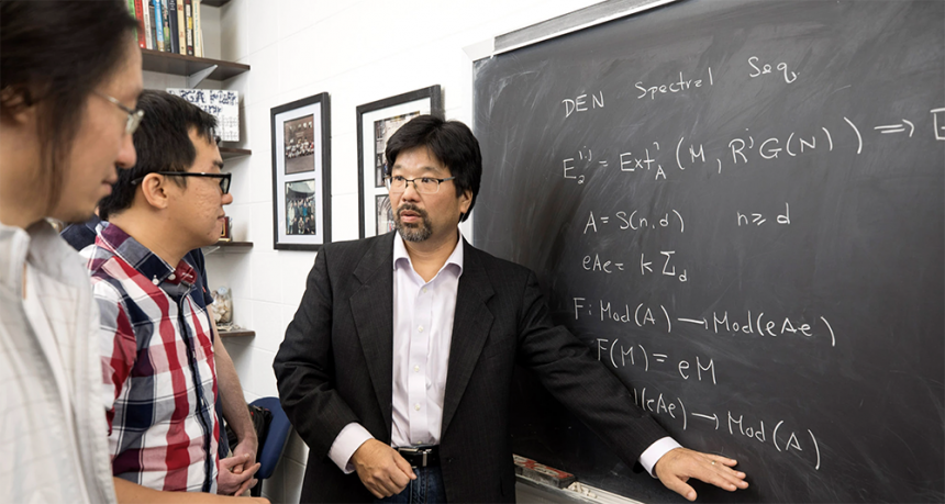 Professor Daniel Nakano interacting with graduate students in his office.